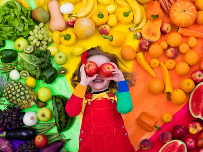 Young child in the midst of fruit